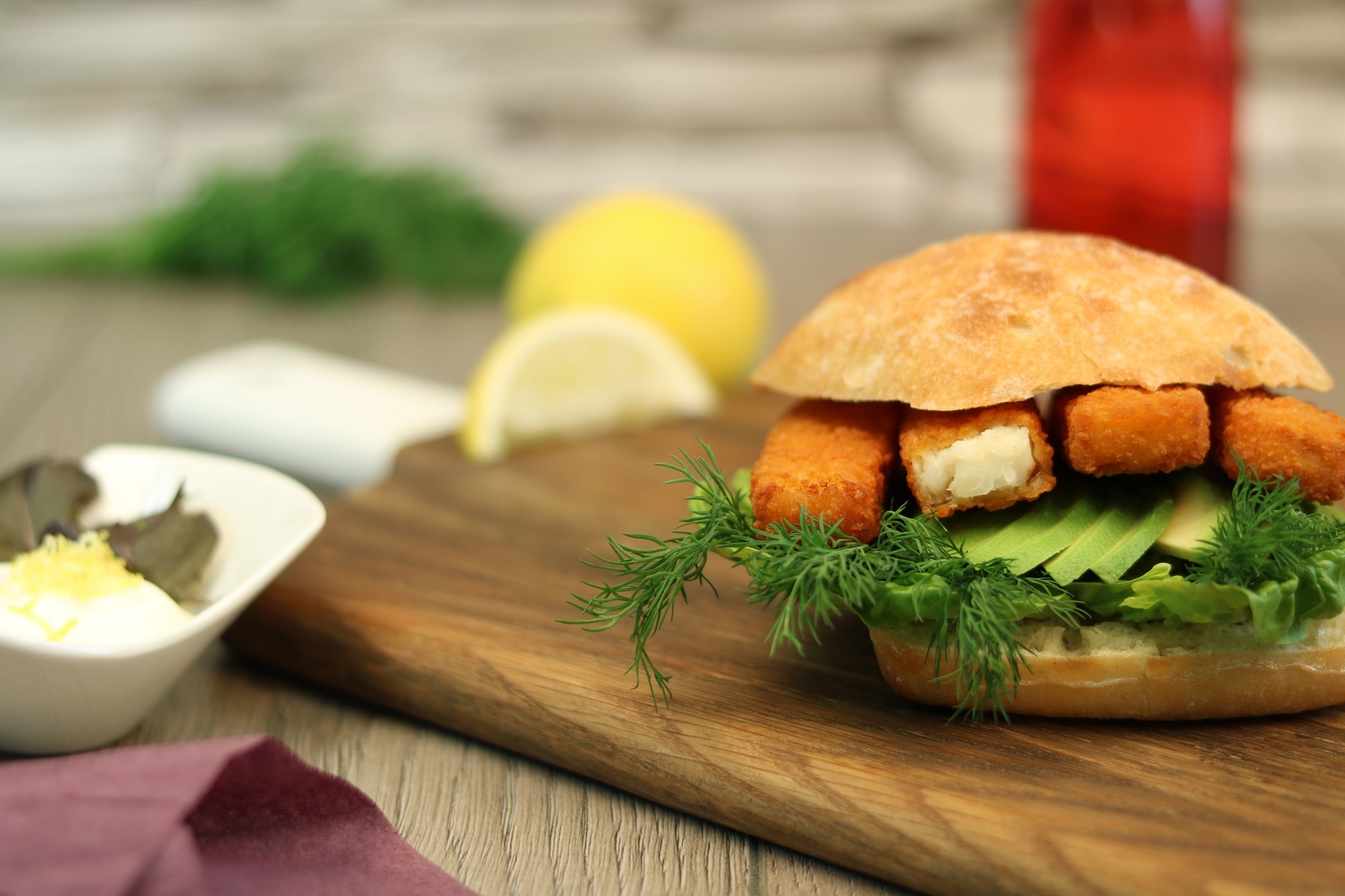 Fish fingers with avocado  dill in a ciabatta roll